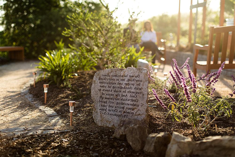 A scripture stone in the Prayer Garden featuring Philippians 4:3-7 